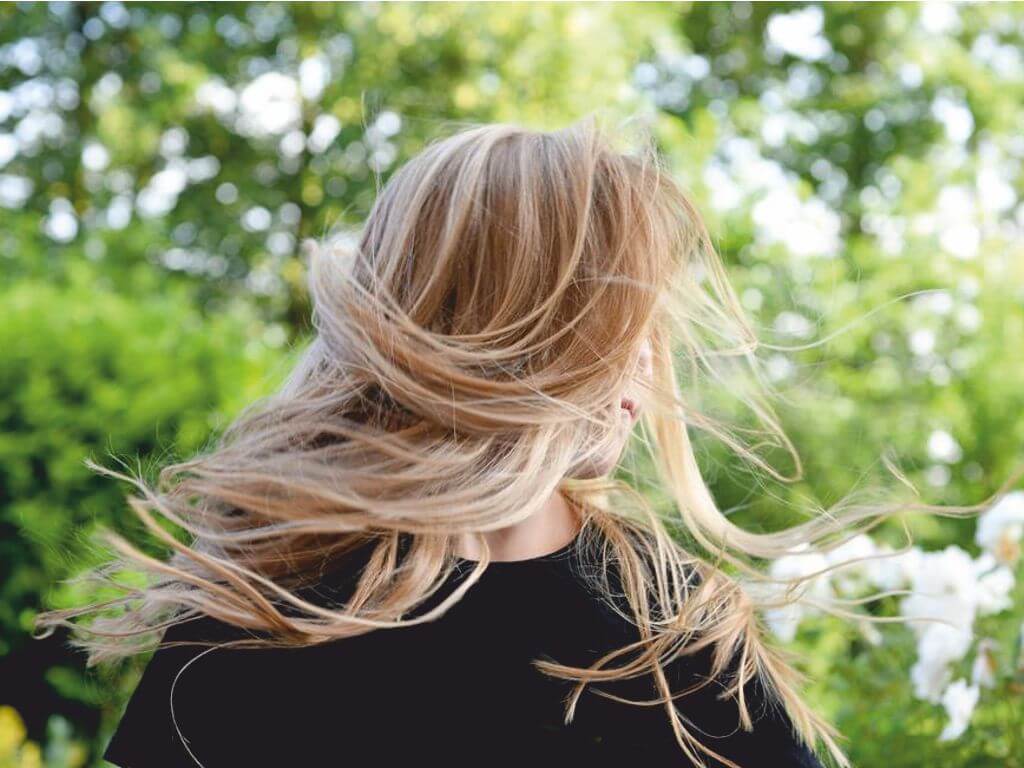 Γυναίκα με υγιή και λαμπερά ξανθά μαλλιά