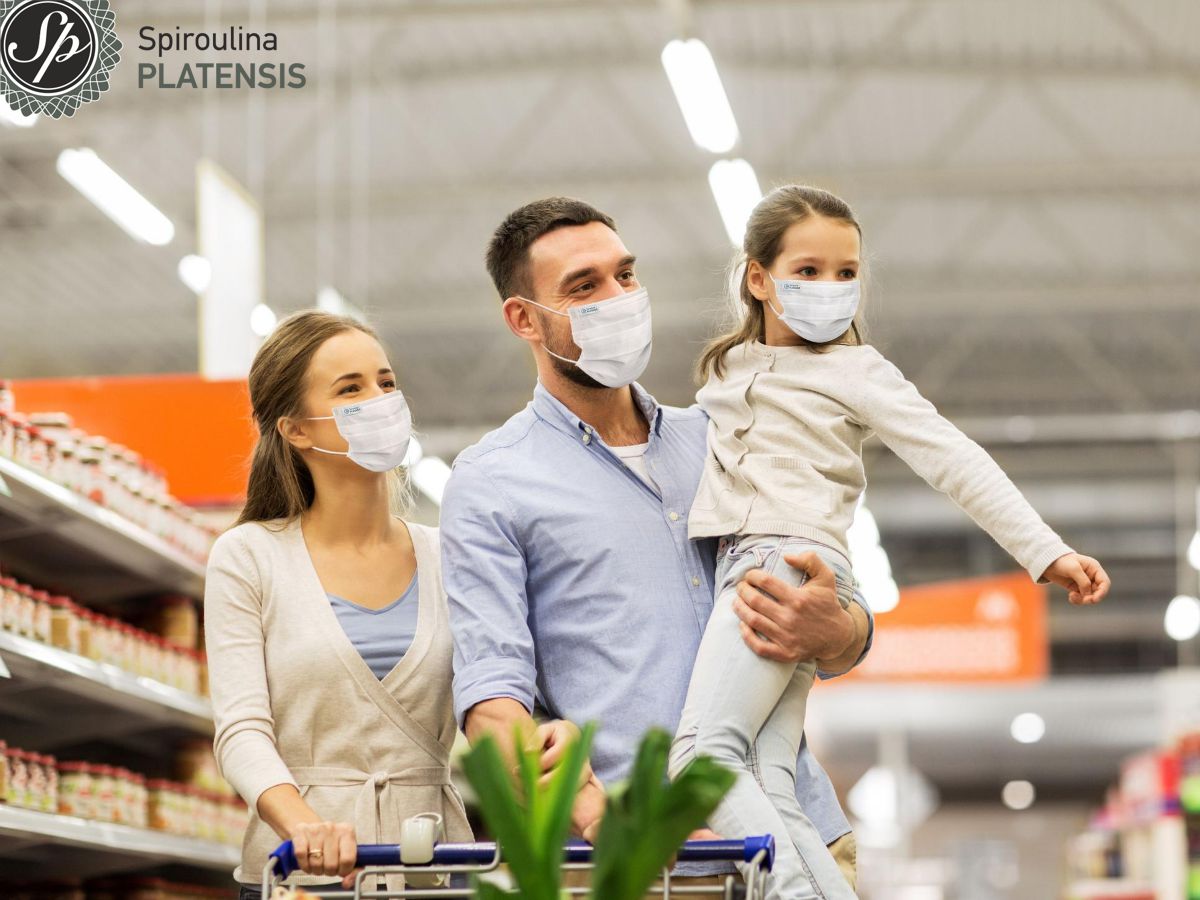 Οικόγενεια με παιδί στο super market με μάσκες Spiroulina PLATENSIS