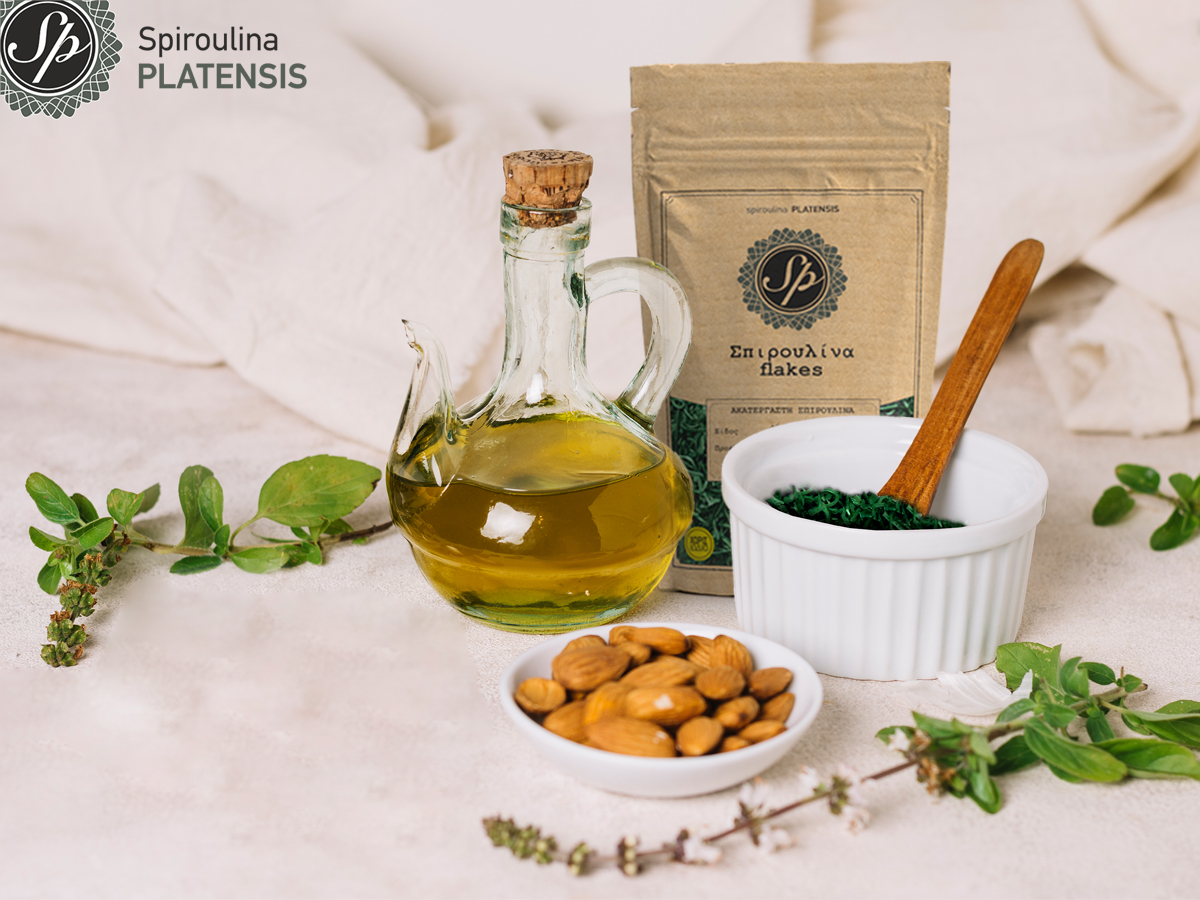 Λάδι, ξηροί καρποί & Σπιρουλίνα flakes σε ένα λευκό πάγκο