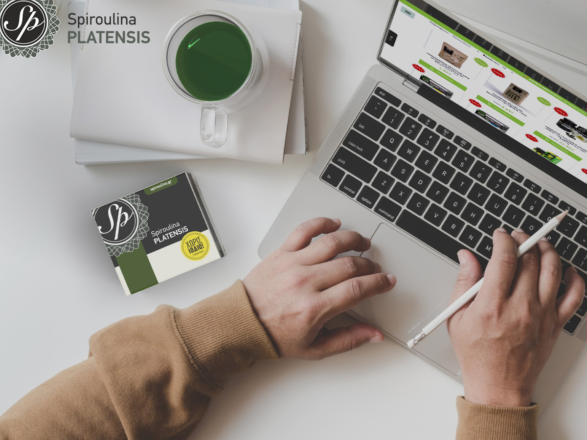 ένα laptop με φόντο το eshop spiroulina.gr και μία συσκευασία spiroulina platensis σε σκόνη