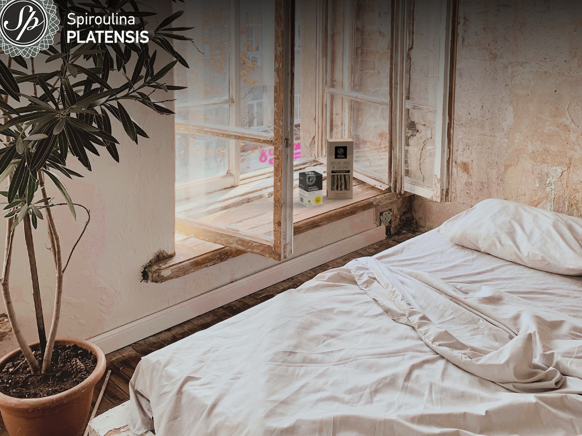 Παράθυρο που πάνω έχει μία συσκευασία κριτσίνια spiroulina PLATENSIS & μία συσκευασία ταμπλέτες spiroulina PLATENSIS χωρίς ιώδιο